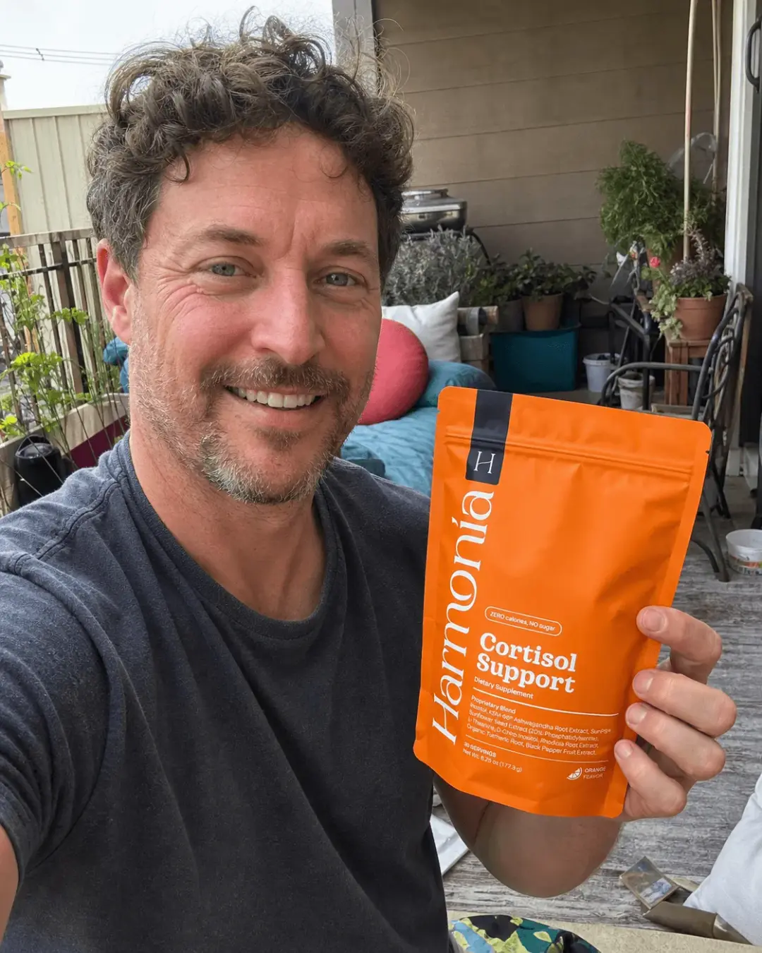 Customer holding Harmonia Cortisol Support product bag